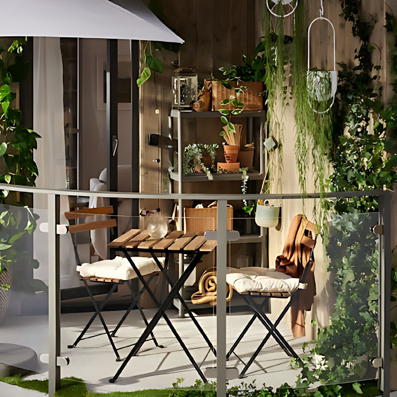 Balcony plants and warm wood tones bring a sense of comfort to this small outdoor space.